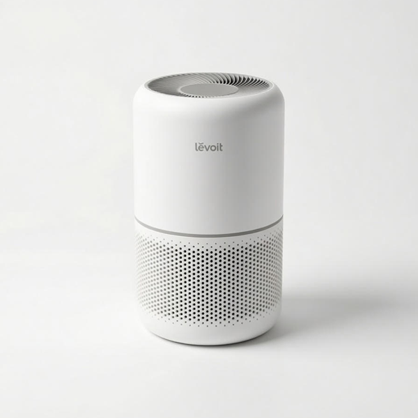 Studio shot of the white cylindrical Levoit Core 300 air purifier. The image shows the 360-degree perforated intake grille on the bottom half, a silver accent ring in the center, and the vortex-style air outlet on the top.