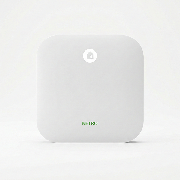 Front view of the Netro Sprite smart sprinkler controller, a compact white square device with a leaf icon button and Netro branding.