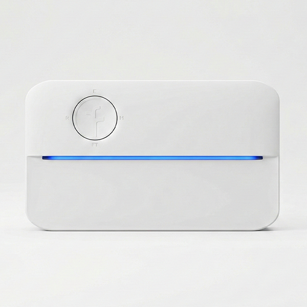Front view of the Rachio smart sprinkler controller, featuring a white rectangular design with a circular control button and a blue LED status bar.