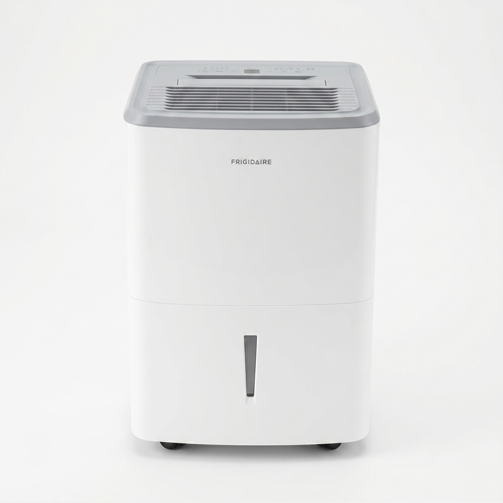 A white Frigidaire upright home dehumidifier. It has a gray exhaust grille and control panel on the top, and a front-loading water bucket with a vertical water level window on the bottom half.