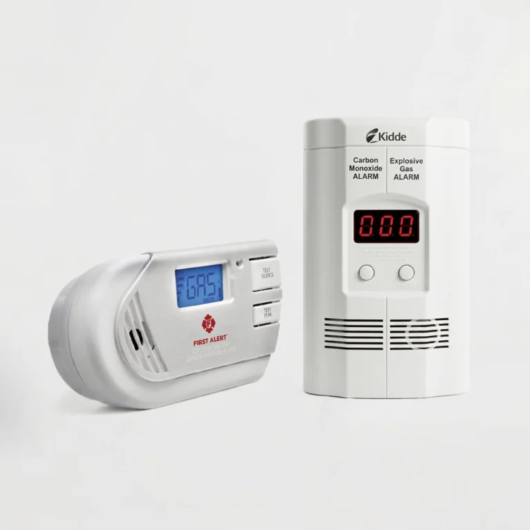 A side-by-side comparison of the First Alert GCO1CN and Kidde KN-COEG-3 combination carbon monoxide and explosive gas detectors on a white studio background, tested for DontPickIt's 2026 home safety review.